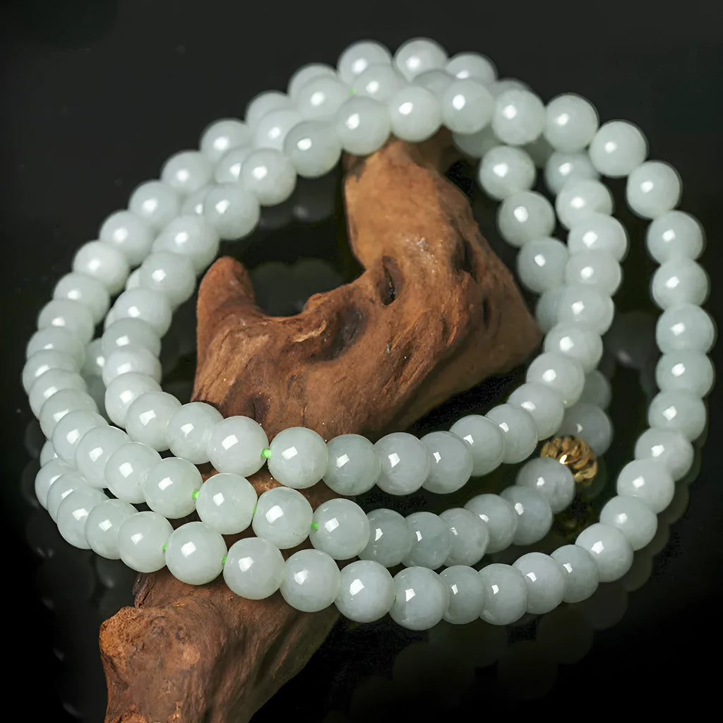 Adjustable length natural jade bead necklace with white and green round beads on a chain.