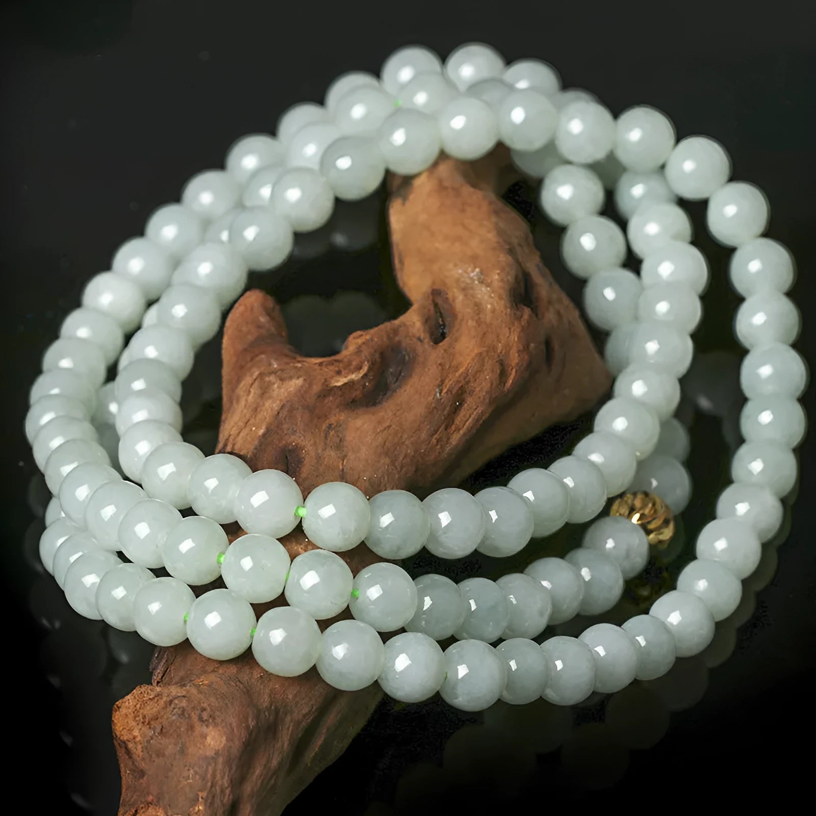 Adjustable length natural jade bead necklace with white and green round beads on a chain.