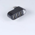 Black and white USB hub with four USB 2.0 ports for computer expansion