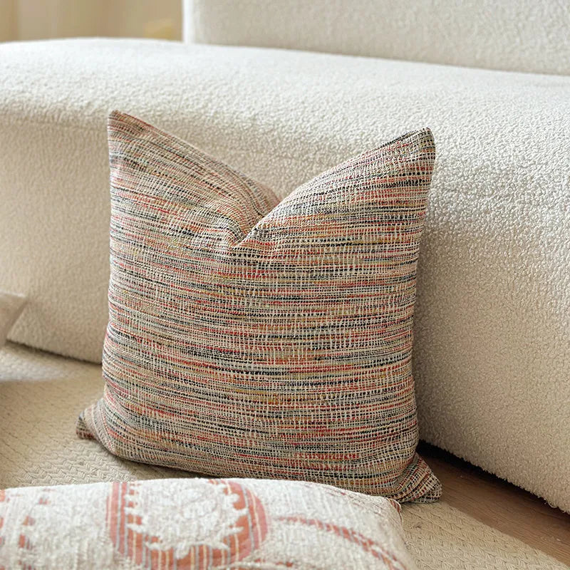 American-style jacquard woven throw pillow cover with a paisley pattern in amber colours on a sofa.