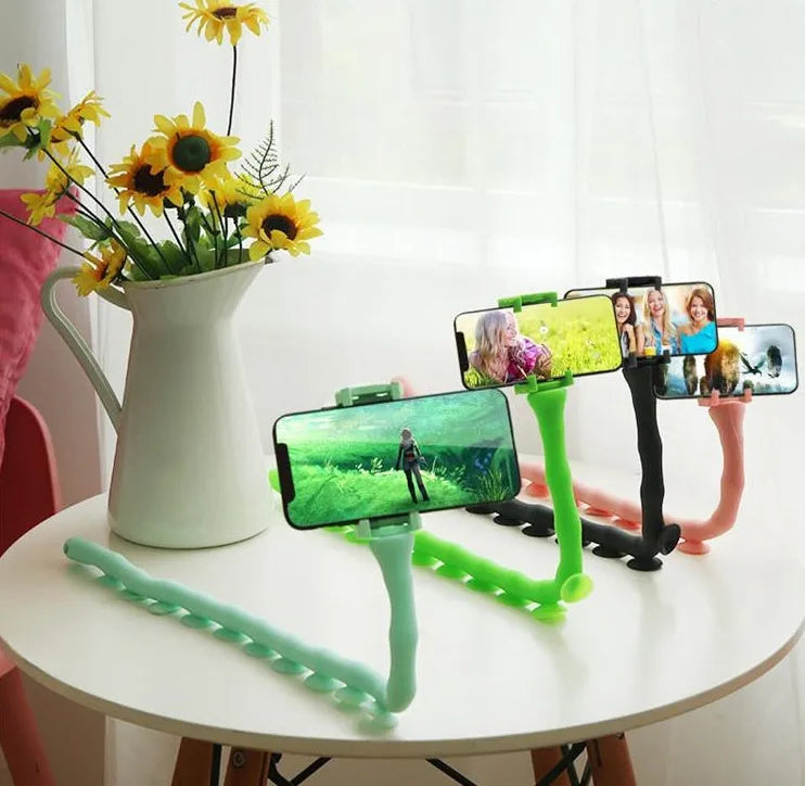 Black flexible rubber phone holder with suction cup base bent into an arc shape