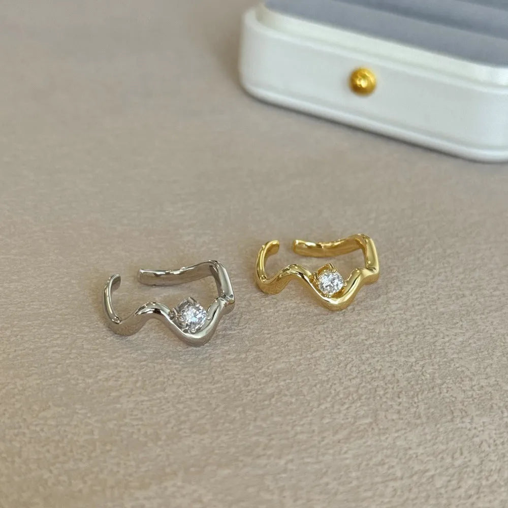 Women's silver electroplated open ring with single diamond and smooth wave line design, white gold tone