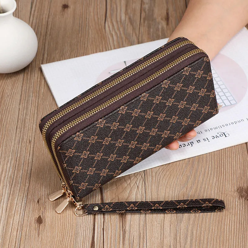 Black retro print long wallet clutch bag with zipper, holding a mobile phone and cards.