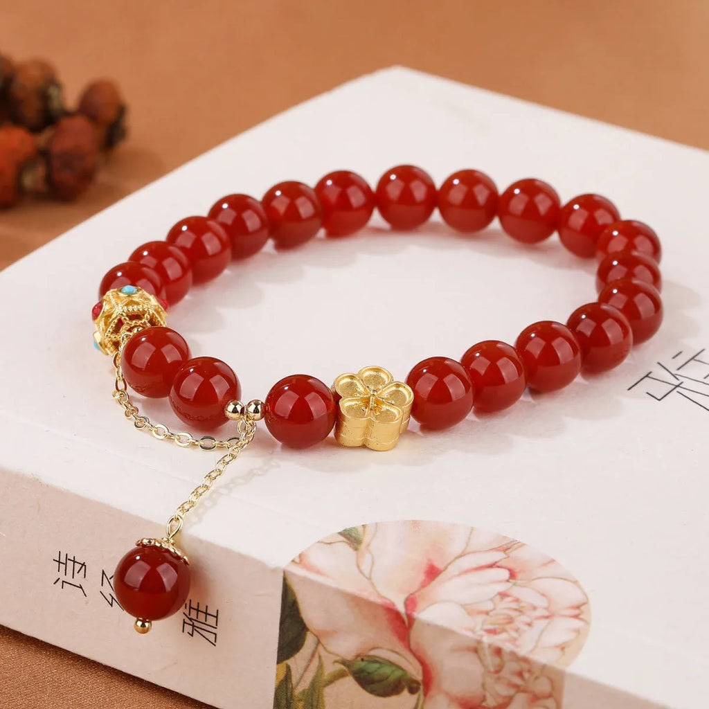 Women's agate bracelet with peach blossom copper parts and approximately 8mm beads in natural red or white stone.