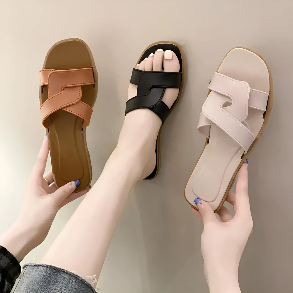 Women's solid-colour cross-strap PVC sandals with a toe-ring design on a non-slip sole.