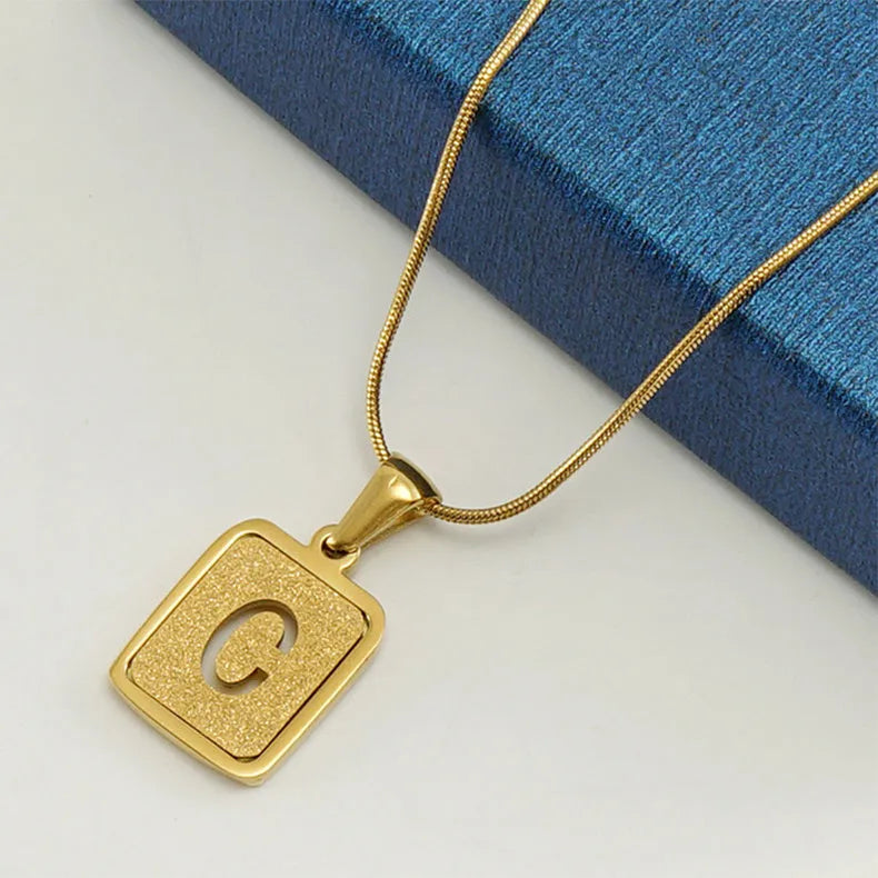 Alphabet necklace with square hollow-out letter pendant in titanium steel, gold or silver electroplated small snake chain