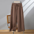 Women's apricot-coloured straight-leg casual trousers with an elastic waistband and white lace-up drawstring detail.