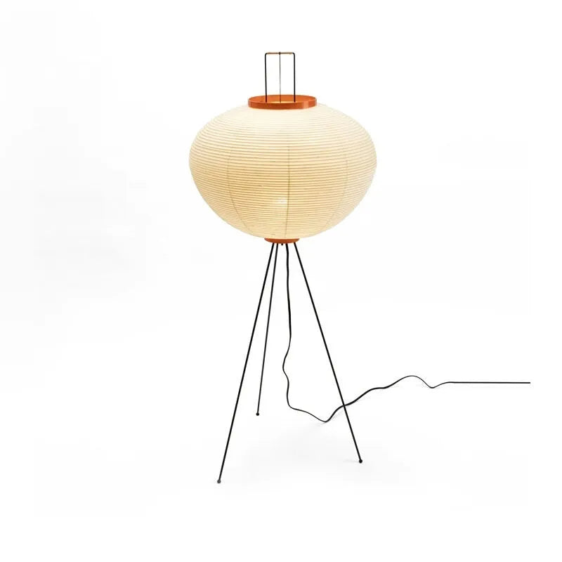 Japanese style rice paper table lamp with aluminium base on a wooden table.