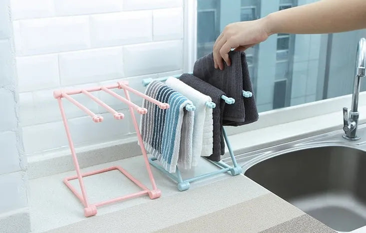 Foldable plastic dishcloth shelf organiser in light blue mounted on wall