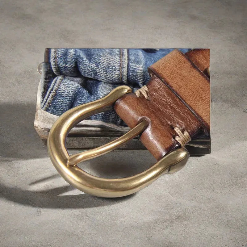 Men's casual leather belt in black with a copper pin buckle on a jeans background