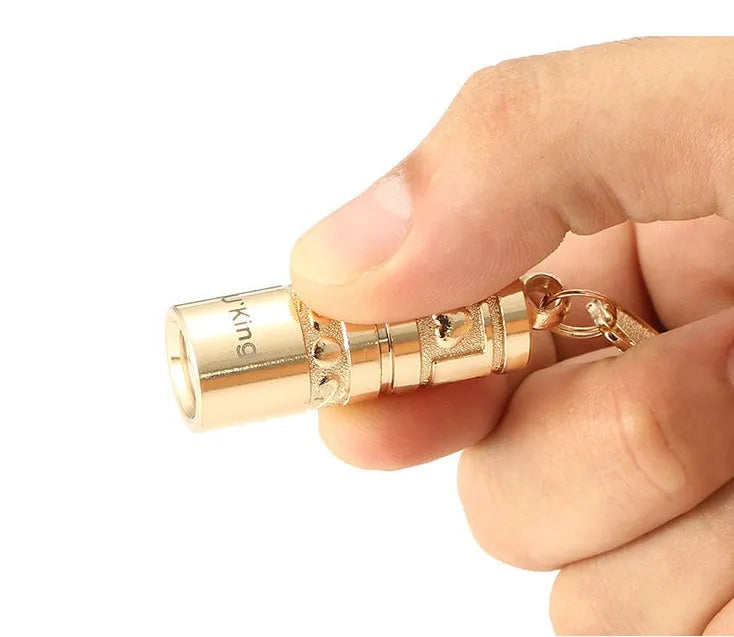 Gold-finish zinc alloy waterproof LED keychain torch with compact design for portable emergency lighting