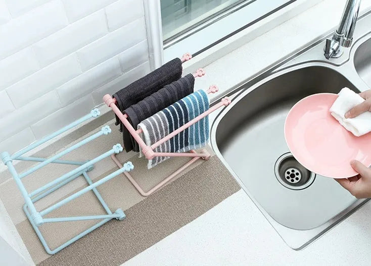 Foldable plastic dishcloth shelf organiser in light blue mounted on wall