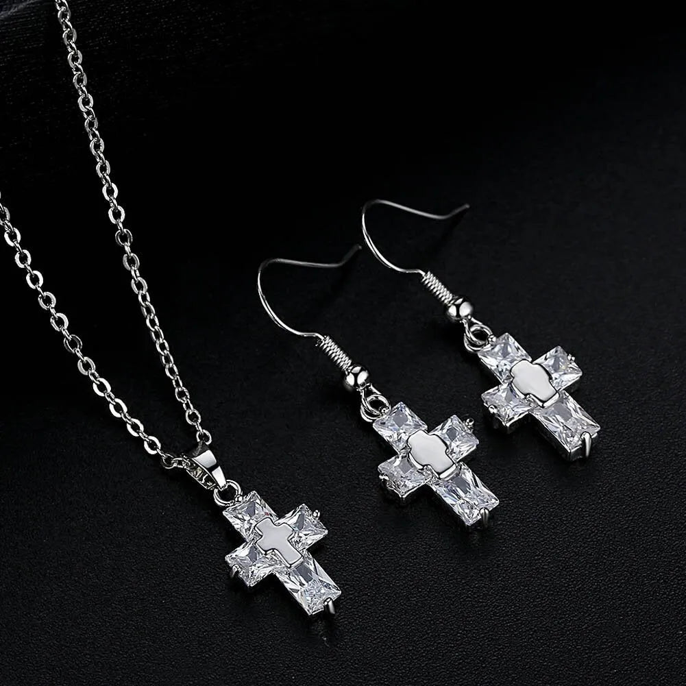 Copper cross ornament set with a 1.2 x 2.2 cm pendant and 3.3 x 1.2 cm studs in gold or silver plated finish
