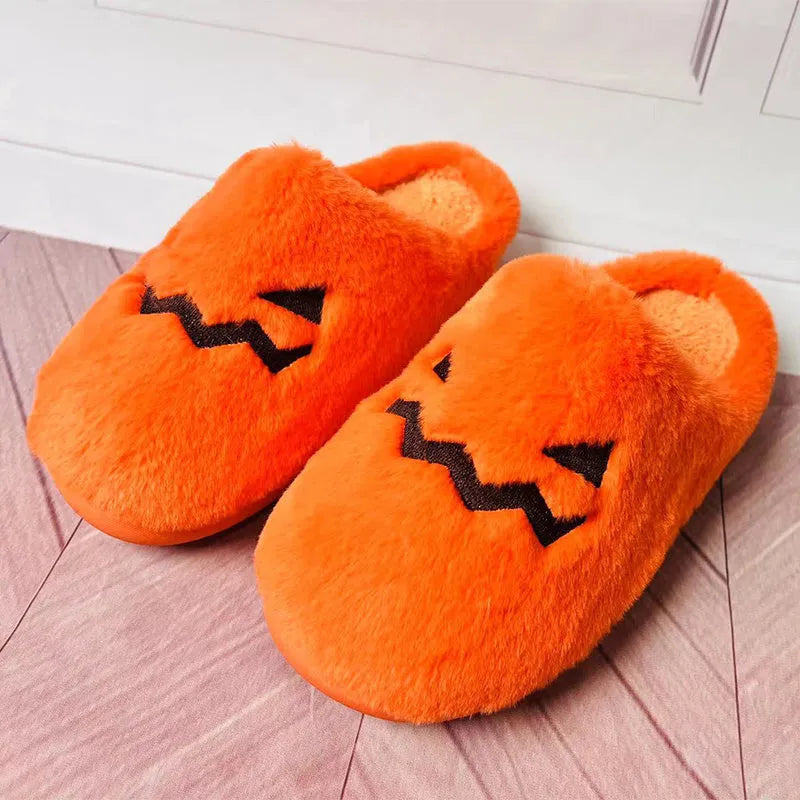 Orange Halloween pumpkin-themed plush indoor slippers with a coral velvet upper and non-slip PVC sole.