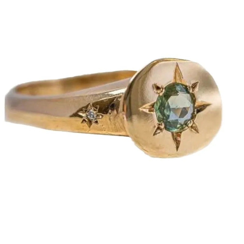 Golden zinc alloy ring with an adjustable opening and a star-shaped zircon asterism design.