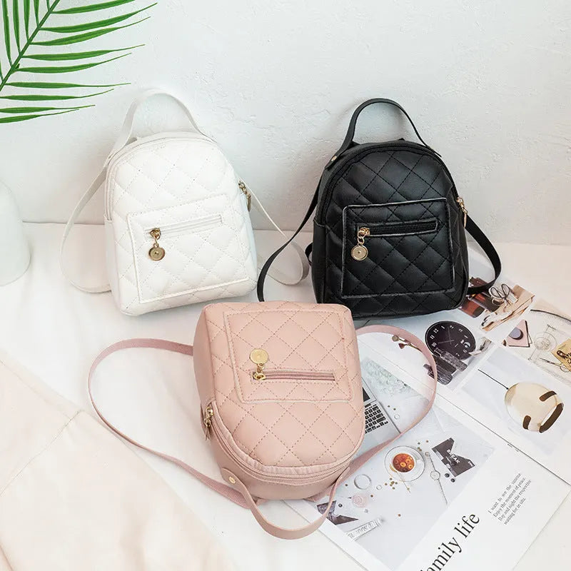 Girls' hard-case embroidered backpack in pink, showing front design and shoulder straps.