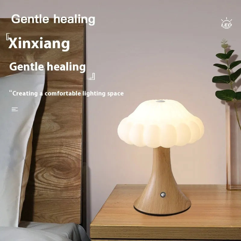 Creative mushroom-shaped night lamp in wood grain colour on a table