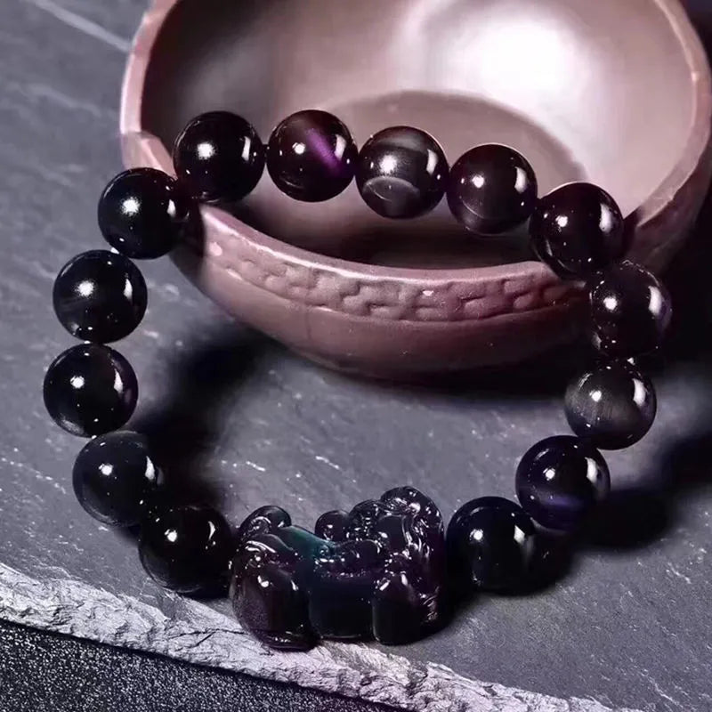 Natural Ice Colour Eye Obsidian crystal bracelet with round beads on an adjustable cord.