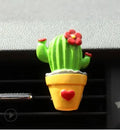 Cute green cactus car air freshener vent clip attached to car air conditioning vent