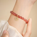 Women's strawberry quartz blessing card bracelet with glass construction and universal wrist size