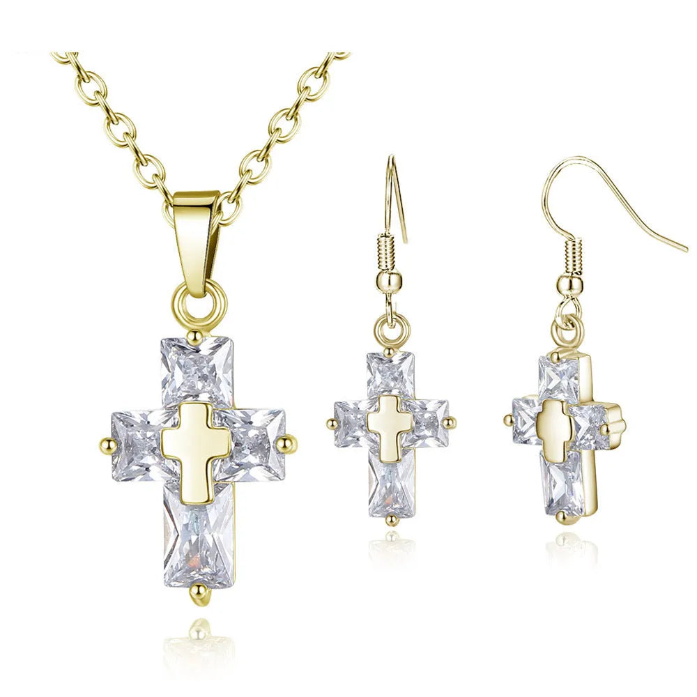 Copper cross ornament set with a 1.2 x 2.2 cm pendant and 3.3 x 1.2 cm studs in gold or silver plated finish