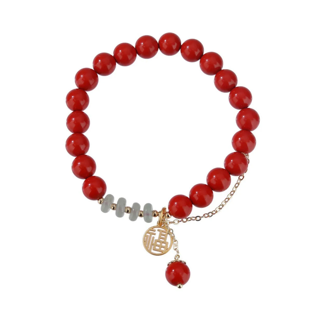 Retro women's bracelet with red sand cinnabar fu character pendant, jade spacer beads, and tassel detailing
