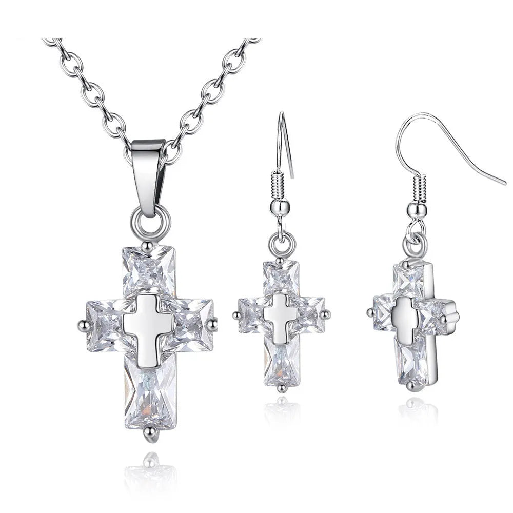 Copper cross ornament set with a 1.2 x 2.2 cm pendant and 3.3 x 1.2 cm studs in gold or silver plated finish