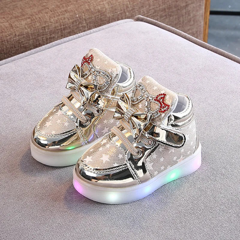 Children's LED light-up trainers with glowing rainbow soles in golden, pink and silvery colours