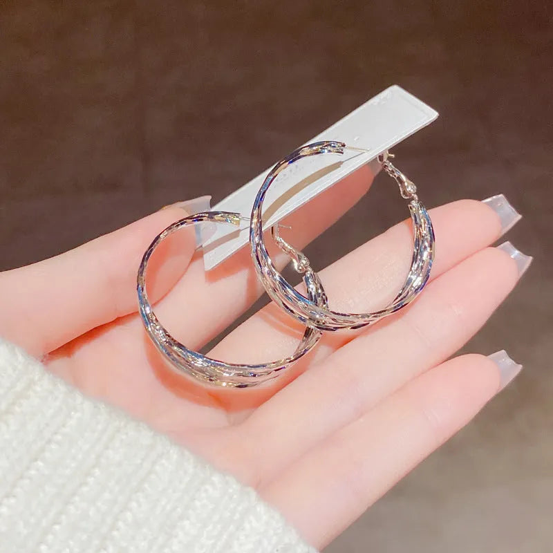 Simple metal twisted earrings for women, copper geometric round shape, available in gold or silver finish