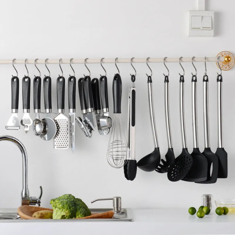 Black silicone spatula set with stainless steel handles containing 16 kitchen utensils