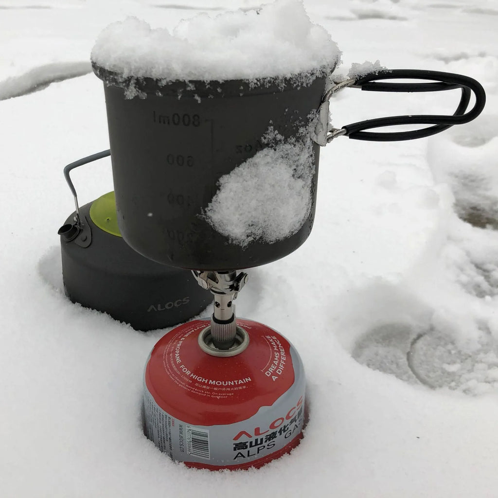 Portable folding mini camping stove made of stainless steel, copper, and aluminium with carry pouch