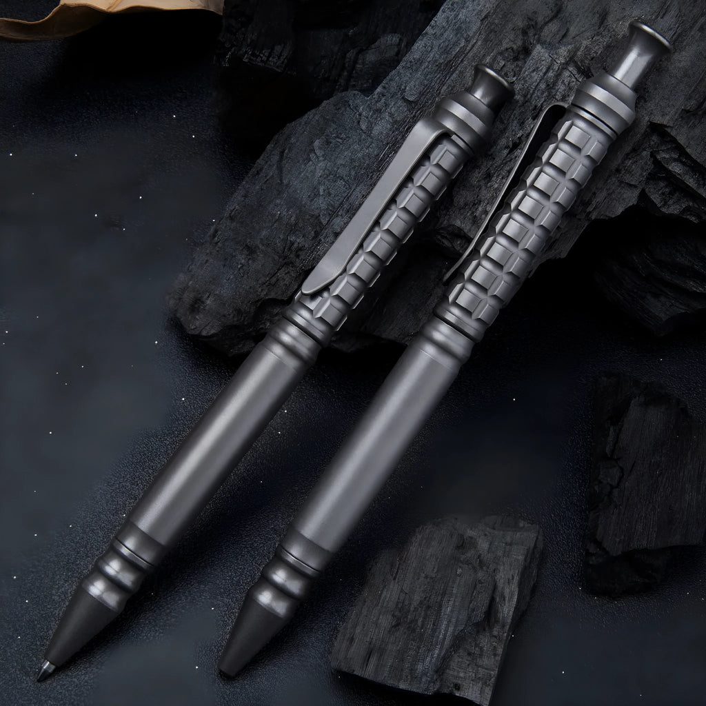 Gunmetal grey titanium tactical pen with push-action decompression mechanism