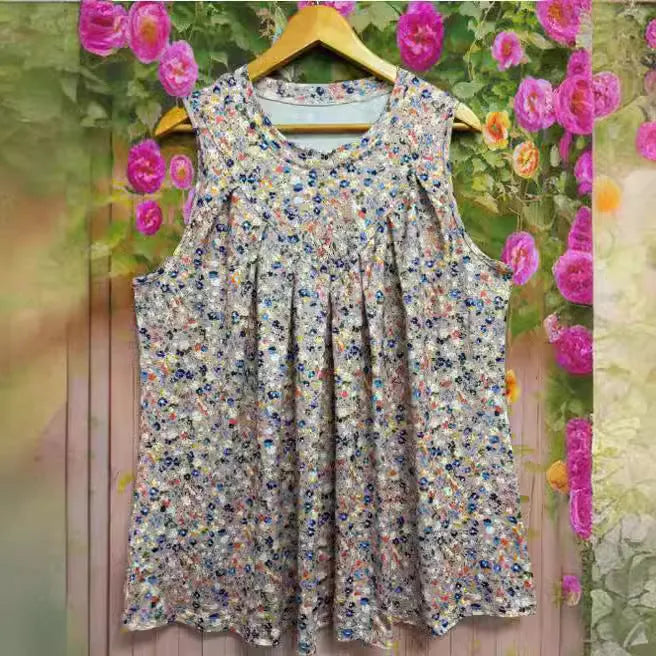 Black plus size floral print sleeveless vest on a hanger, showing loose fit and round neck.