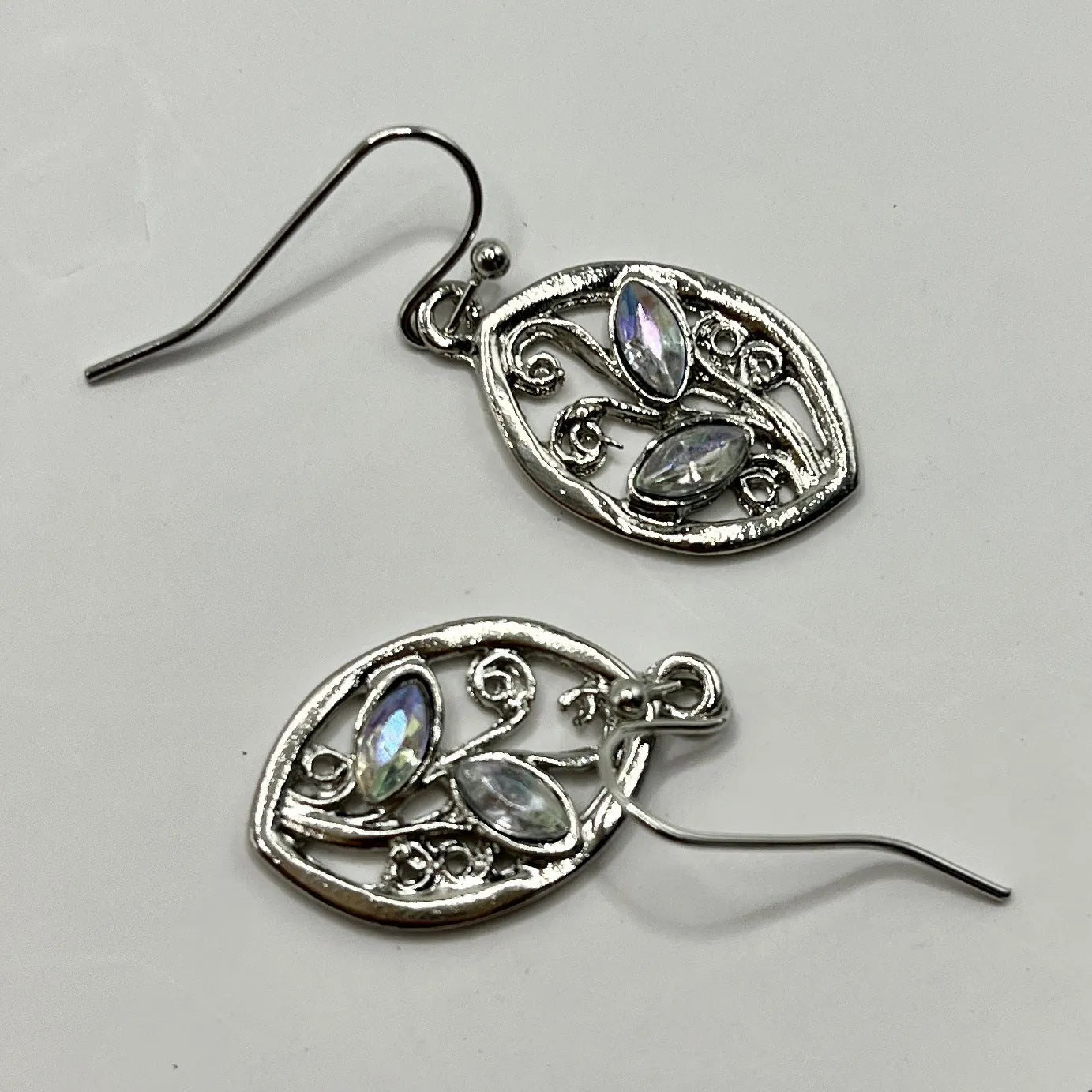 Silver alloy leaf-shaped earrings with an embedded colourful moonstone centrepiece.