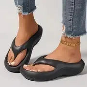 Women's black EVA flip flops with thick sole and textured footbed, shown from above.