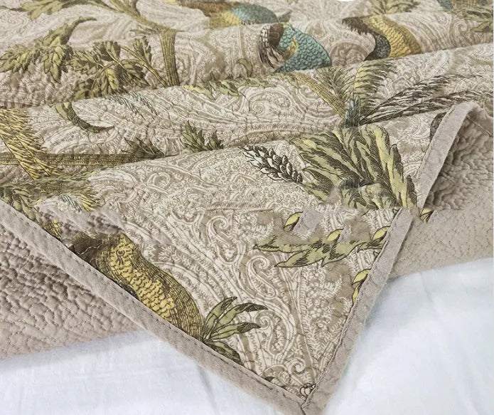Blue cotton bedspread with American floral and bird pattern, part of a 3-piece quilt set.