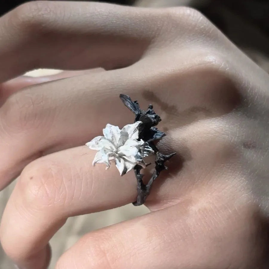 Bipolar Disorder French Simplicity copper ring in white and black with lily motif on neutral background