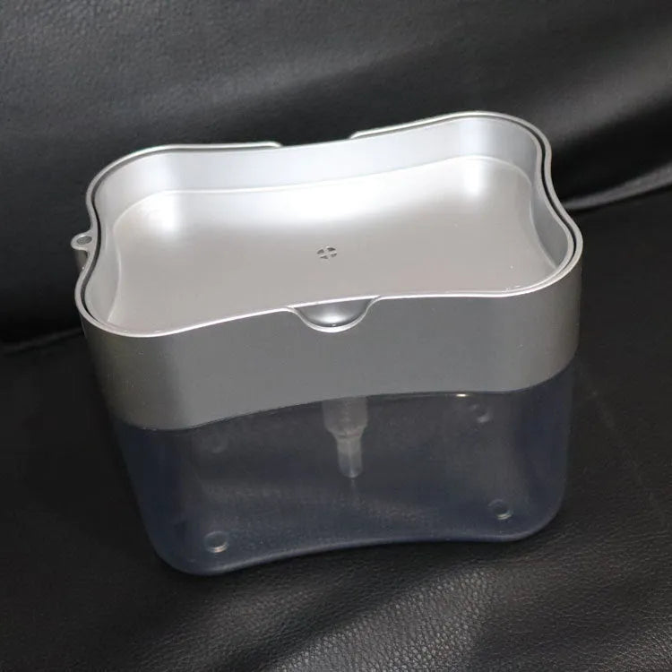 A grey plastic soap dispenser with a pump top on a kitchen countertop