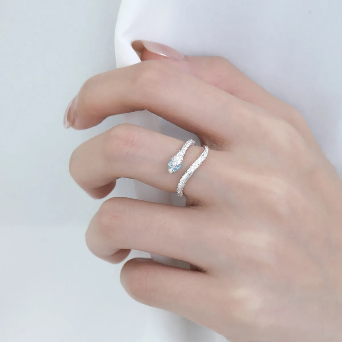 Women's adjustable silver snake zodiac ring in platinum colour.