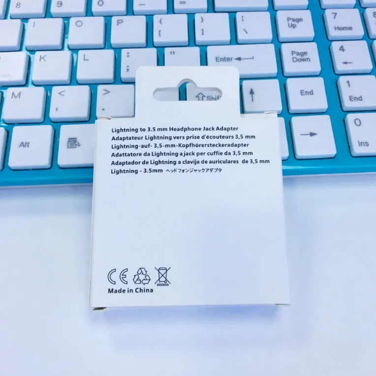 White Lightning to 3.5mm female headphone jack adapter for iPhone compatibility.