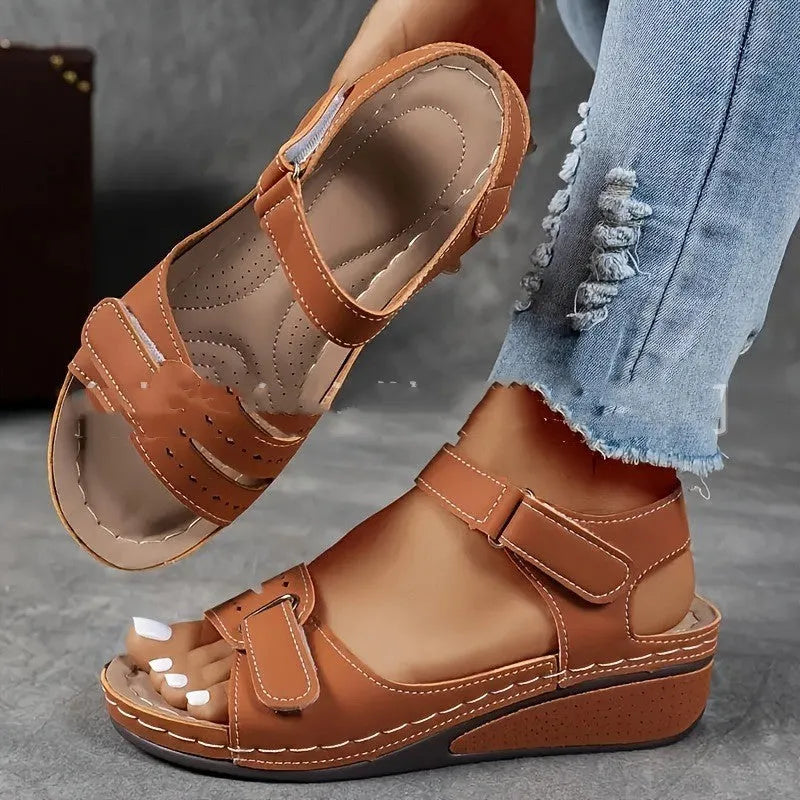 Beige wide fit sandals with thick composite sole and adjustable Velcro straps on a white background.