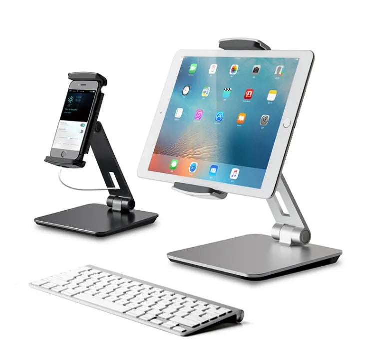 Folding aluminium desktop stand holding a tablet, showing its 360-degree rotation hinge and black/silver colour options.