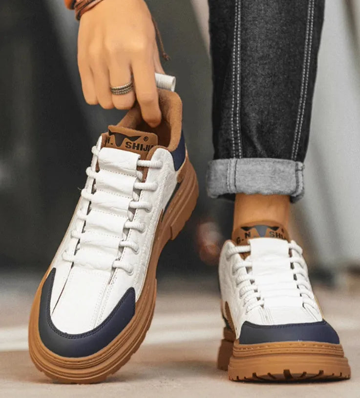 Black and white platform casual sneakers with thick rubber soles and colour-panelled pattern detailing