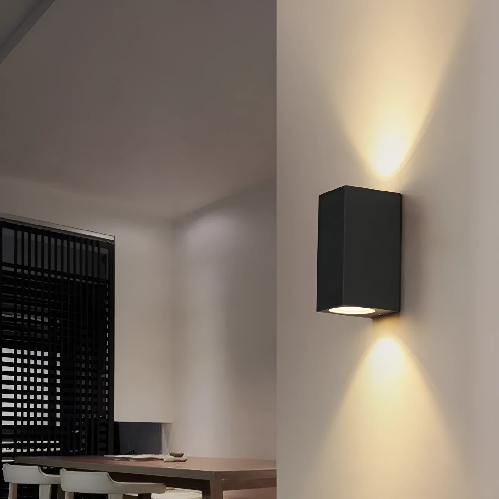 Modern aluminium LED wall lamp in a black finish mounted on a wall.