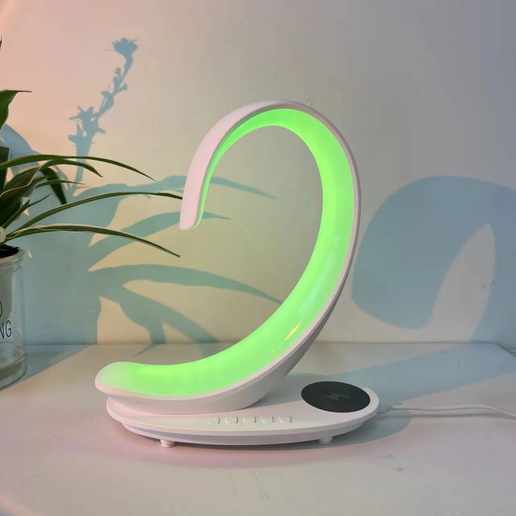 White swan-shaped desktop device with wireless charging, Bluetooth speaker, and colourful mood lighting functions