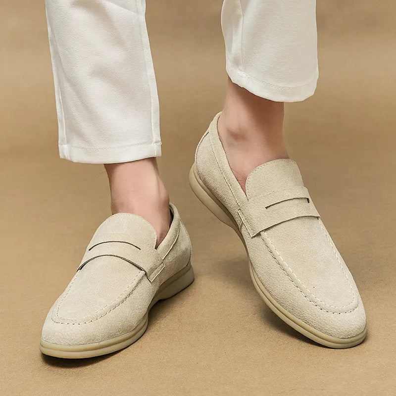 Men's beige leather slip-on casual shoes with a round toe and mid heel on a rubber sole.