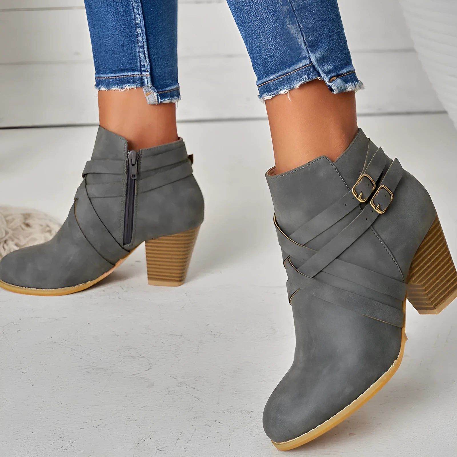 Grey women's plus size ankle boots with a 7cm chunky heel, side zipper, and belt buckle detail.