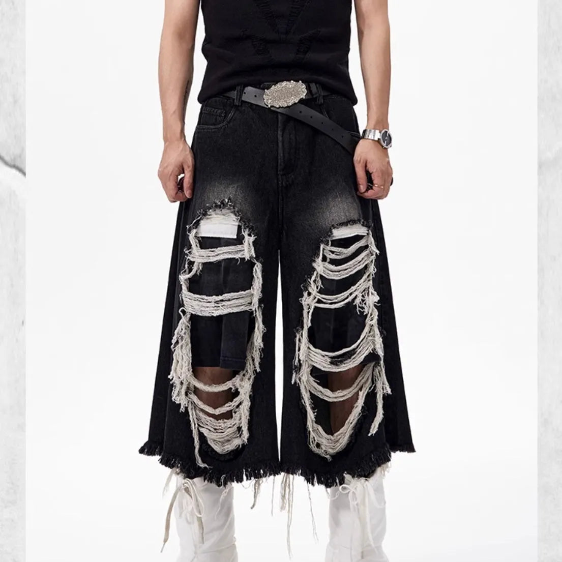 Black women's wide-leg cropped jeans with ripped patchwork details on cotton denim.