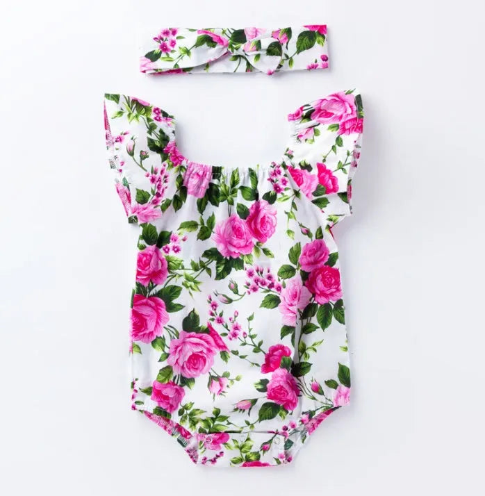 Baby girl wearing sleeveless black romper with small flying sleeves, triangle climbing style