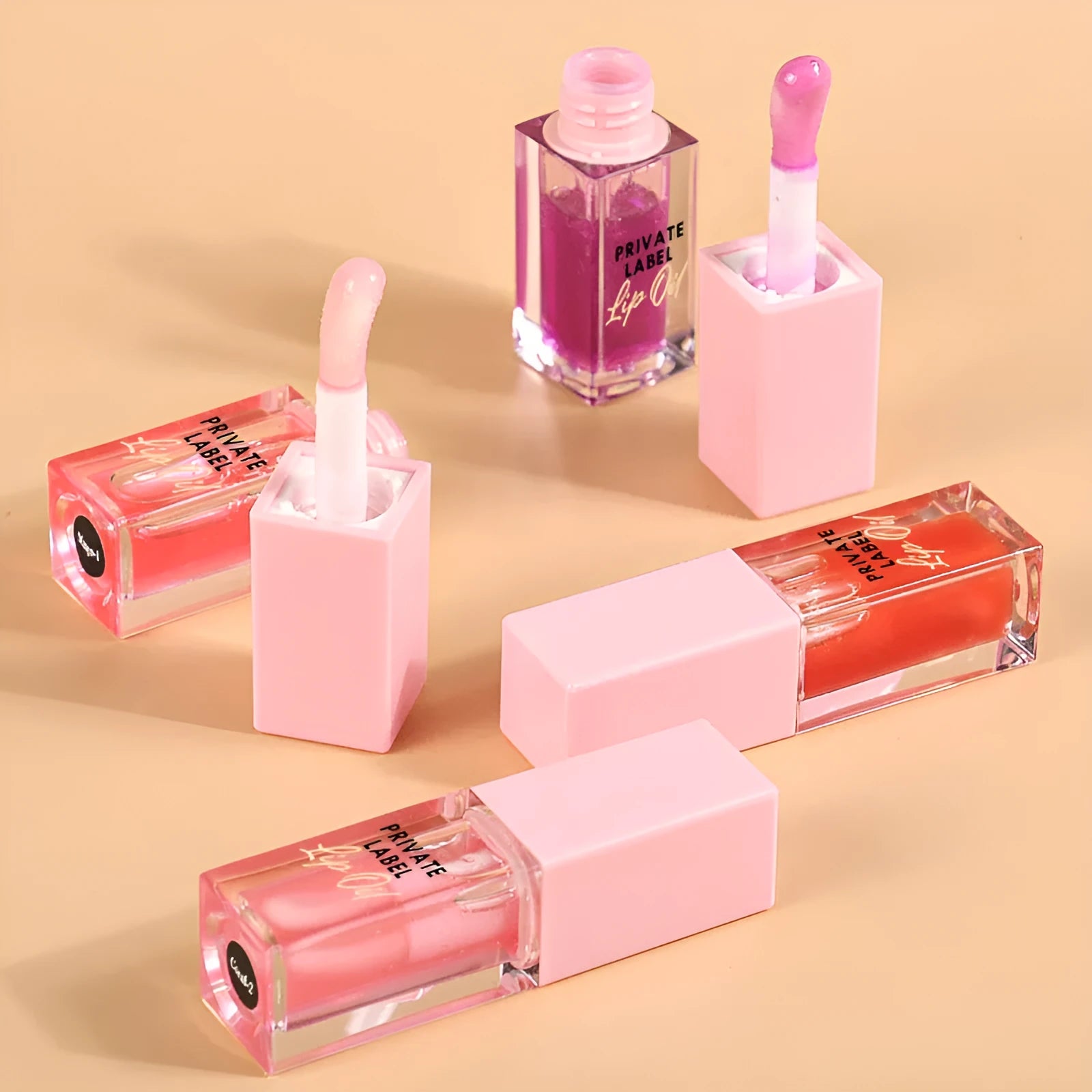 Set of six transparent lip gloss tubes in fruity flavours including cherry and watermelon